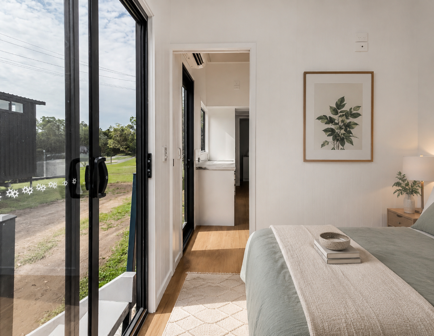 Kingfisher 9 bedroom with framed botanical print and green outlook