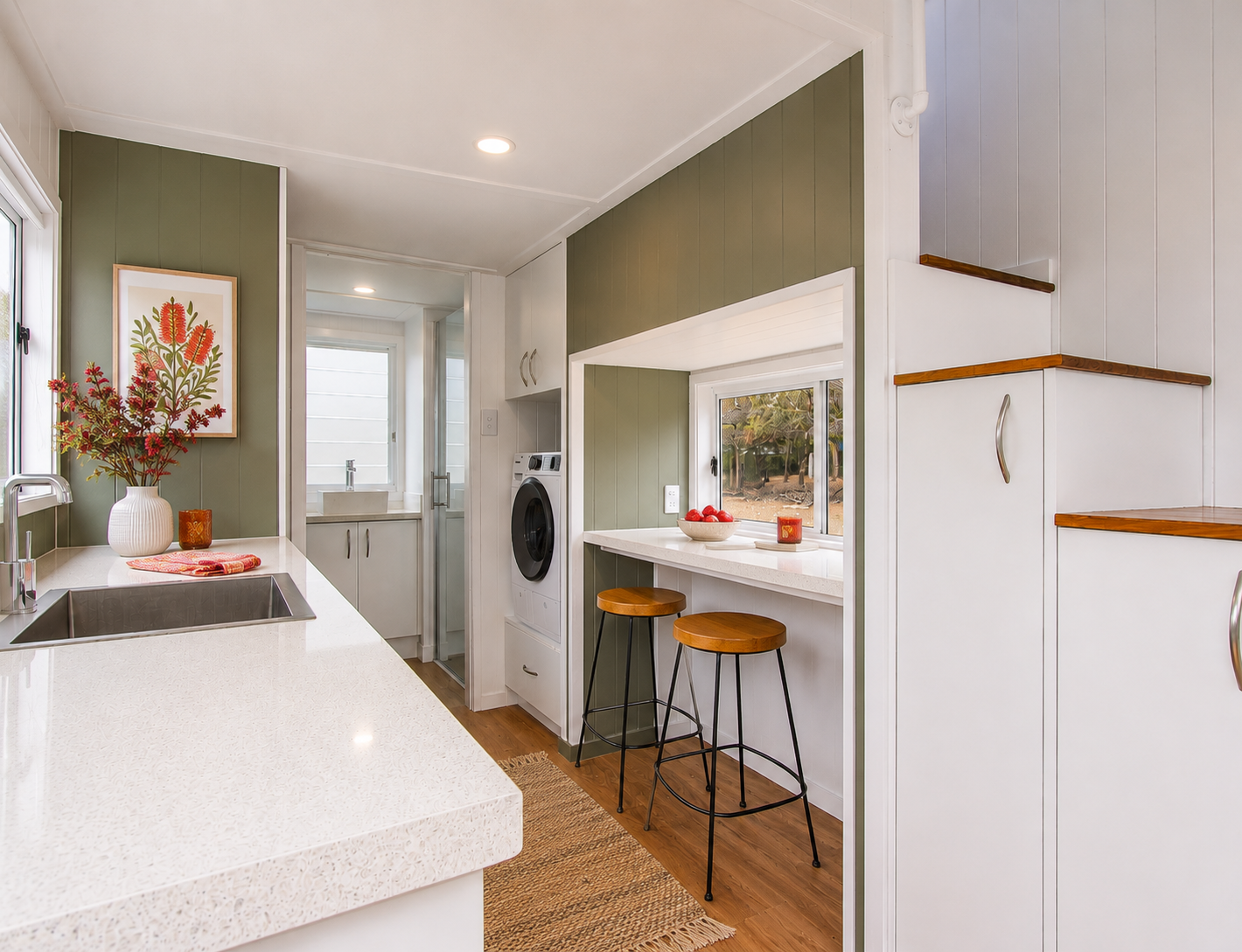 Kingfisher 9 interior — sage green panelling with timber breakfast bar and stools