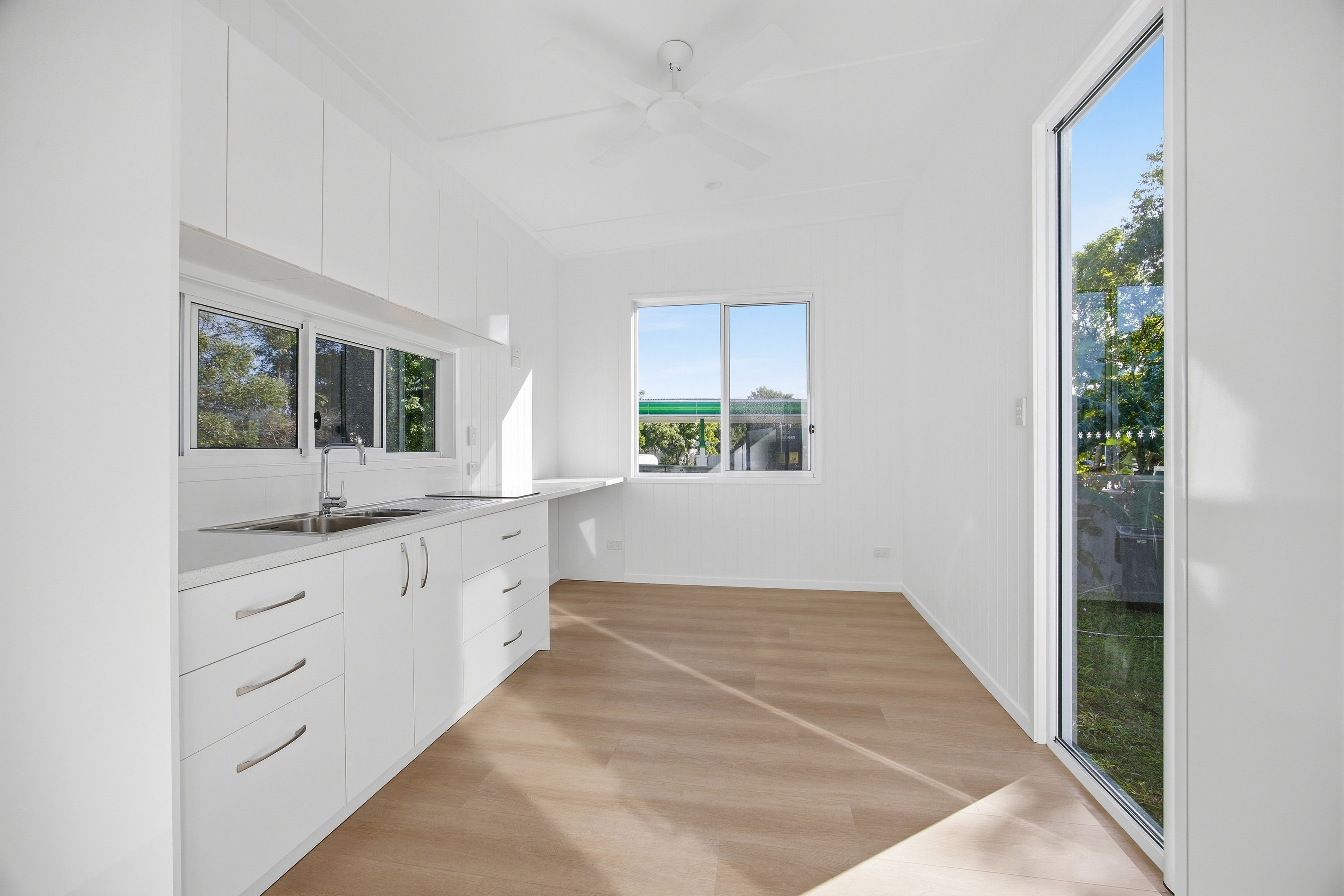 Magpie 9 interior — light-filled kitchen with full-height glass door