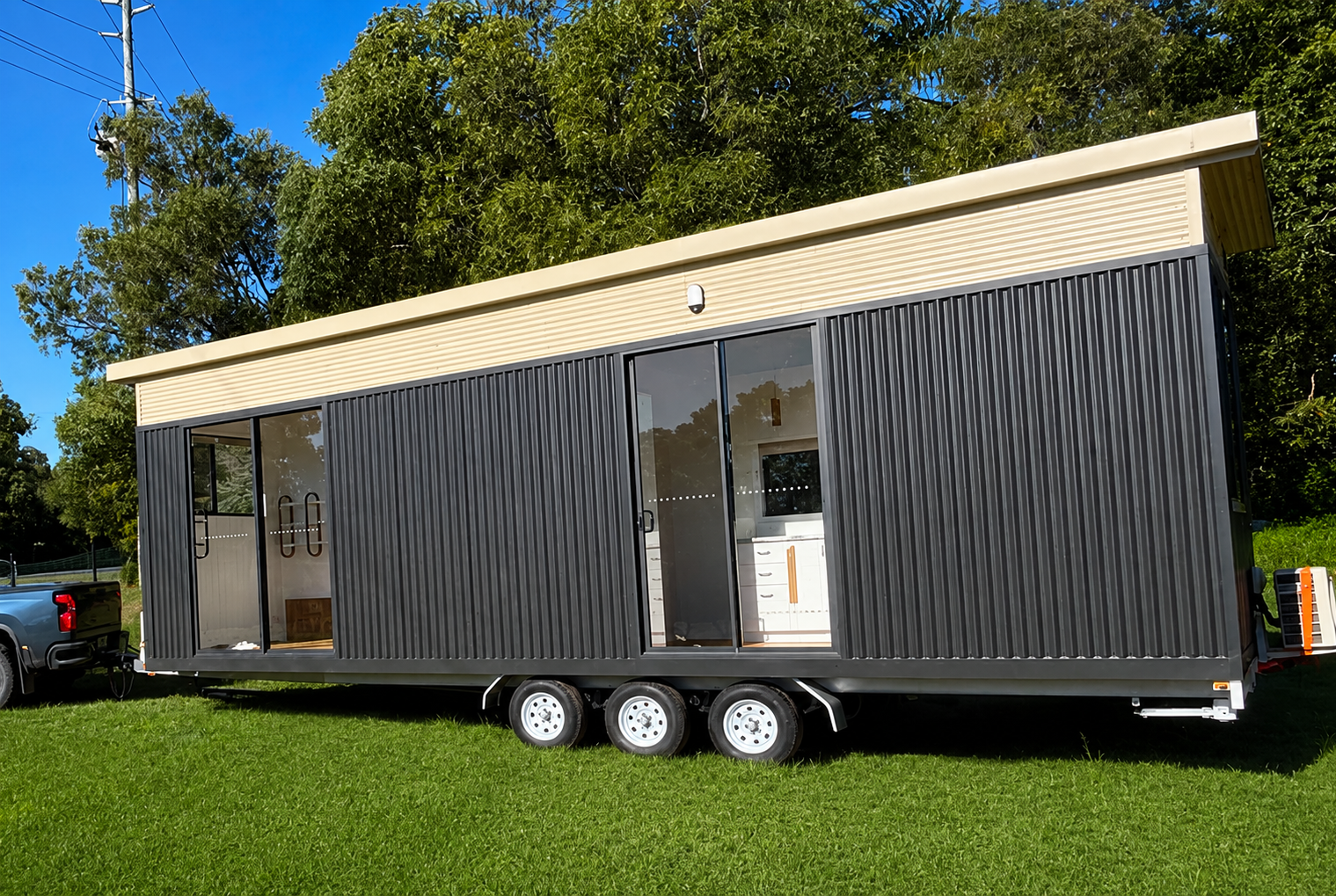 Tiny home on a registered trailer being towed by a ute