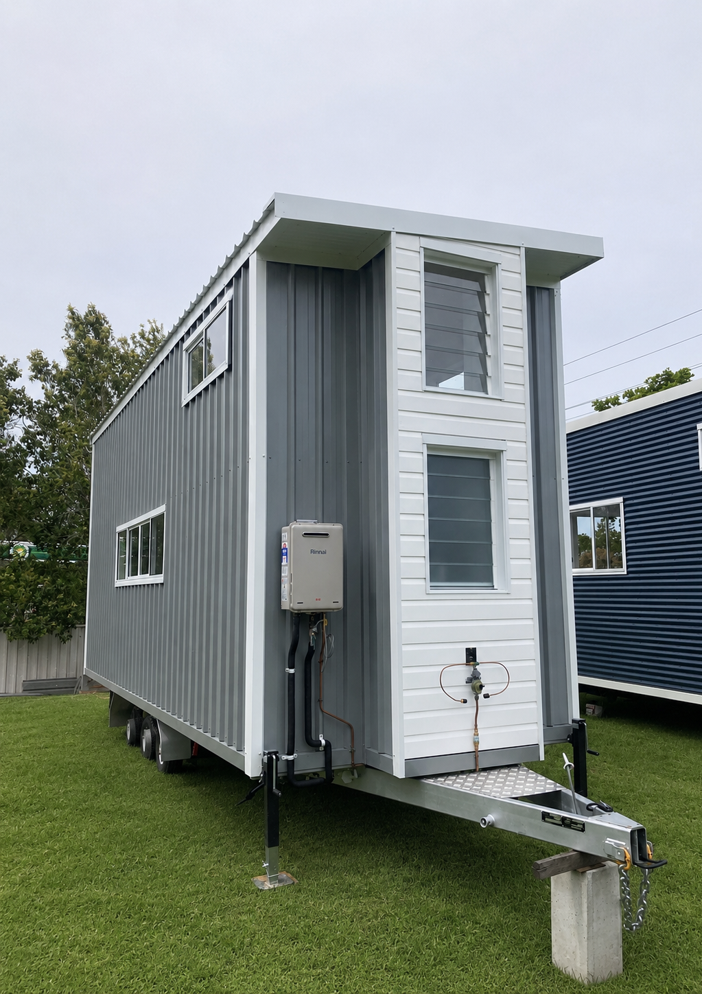 A tiny home on its trailer in the build yard